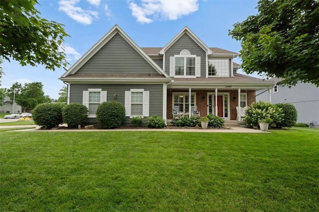 12499 S Marion St, Olathe, KS 66061 - view of front of home with a front lawn, covered porch, and brick siding