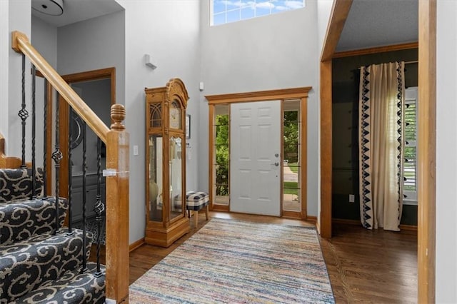 12499 S Marion St, Olathe, KS 66061 - foyer entrance featuring stairway, wood finished floors, and a towering ceiling