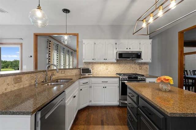 12499 S Marion St, Olathe, KS 66061 - kitchen featuring stainless steel appliances, dark stone countertops, dark wood-type flooring, white cabinets, and tasteful backsplash