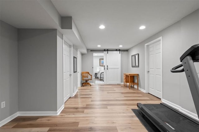 12499 S Marion St, Olathe, KS 66061 - workout area featuring recessed lighting, light wood finished floors, and a barn door