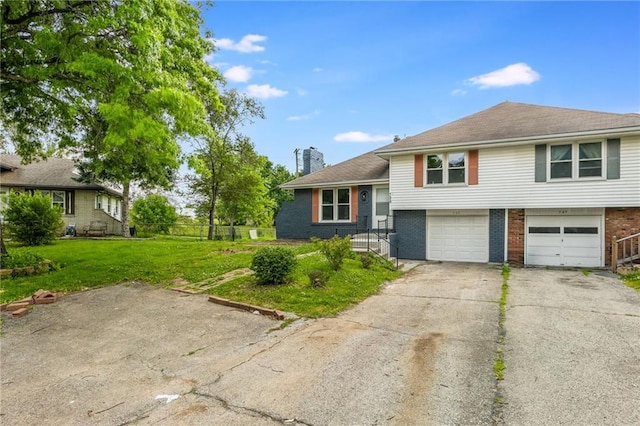 729 S Central St, Olathe, KS 66061 - split level home featuring brick siding, a chimney, asphalt driveway, a garage, and a front yard