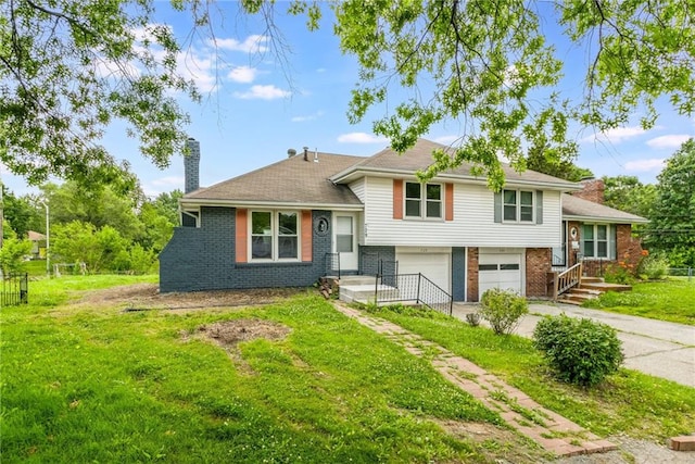 729 S Central St, Olathe, KS 66061 - tri-level home featuring a chimney, brick siding, an attached garage, driveway, and a front lawn