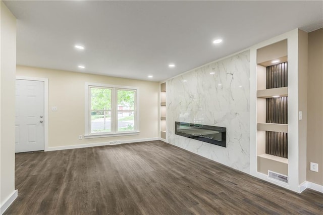 729 S Central St, Olathe, KS 66061 - unfurnished living room featuring built in shelves, a fireplace, wood finished floors, and recessed lighting