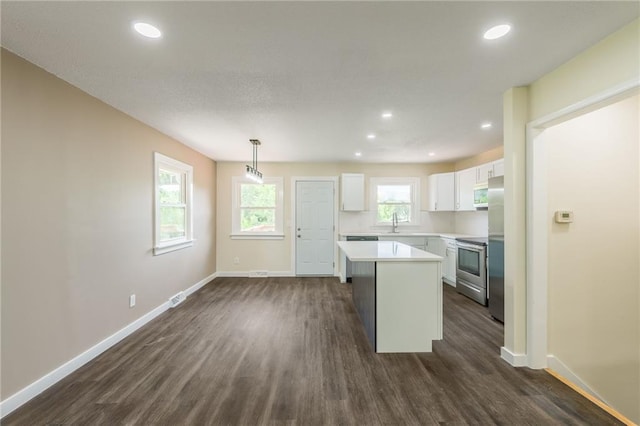 729 S Central St, Olathe, KS 66061 - kitchen featuring white cabinets, dark wood-style floors, light countertops, stainless steel appliances, and recessed lighting
