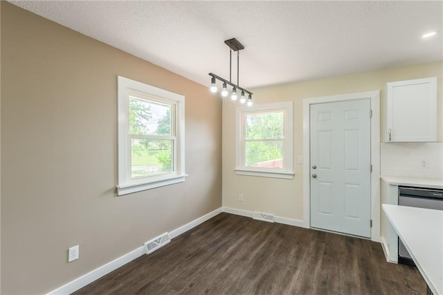 729 S Central St, Olathe, KS 66061 - unfurnished dining area with dark wood-type flooring and a textured ceiling