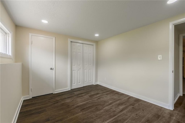 729 S Central St, Olathe, KS 66061 - unfurnished bedroom with dark wood-style flooring, recessed lighting, a closet, and a textured ceiling