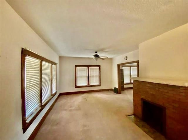 320 W Walnut St, Nevada, MO 64772 - unfurnished living room featuring a ceiling fan, carpet, and a fireplace