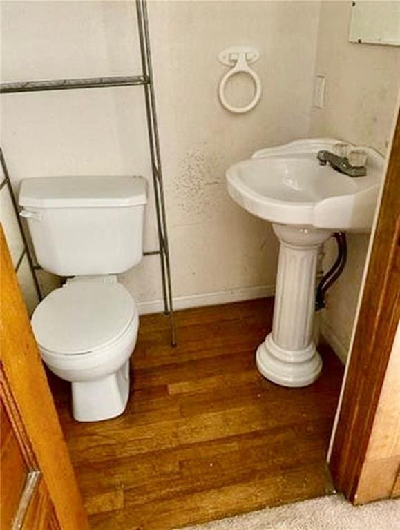 320 W Walnut St, Nevada, MO 64772 - half bath featuring wood finished floors and toilet
