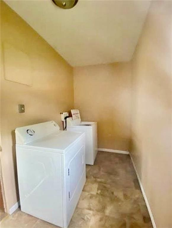 320 W Walnut St, Nevada, MO 64772 - washroom featuring washing machine and dryer and baseboards