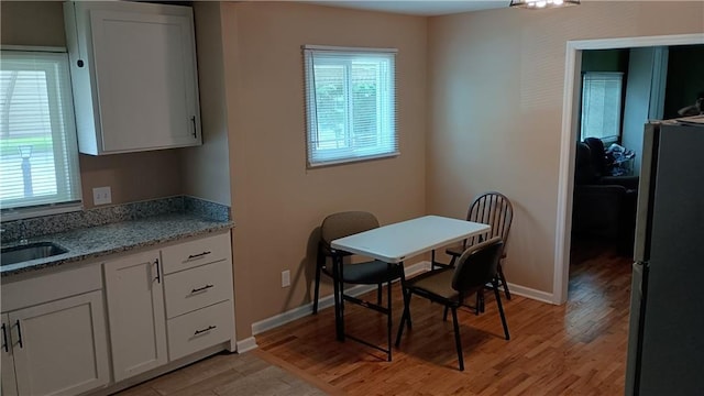 107 N 20th St, Leavenworth, KS 66048 - dining area with light wood-style flooring and baseboards