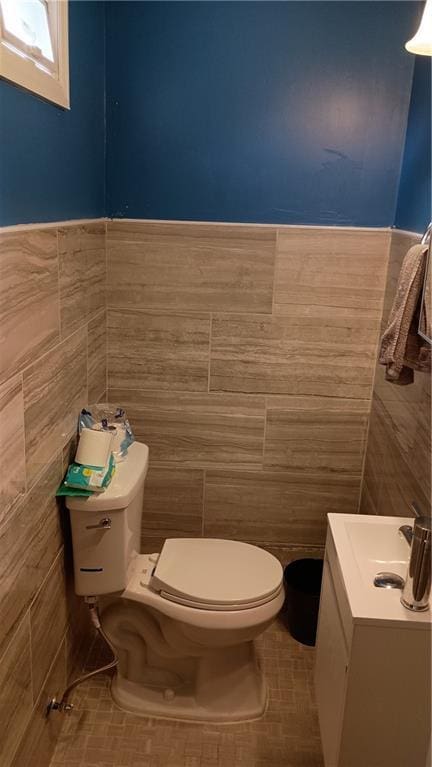 107 N 20th St, Leavenworth, KS 66048 - bathroom featuring tile walls, vanity, tile patterned flooring, and wainscoting