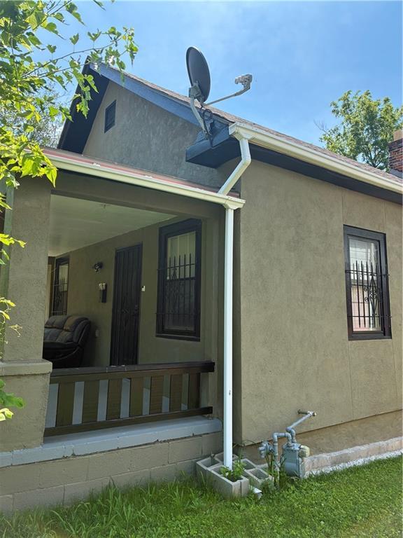 4123 E 6th St, Kansas City, MO 64124 - back of house with covered porch and stucco siding