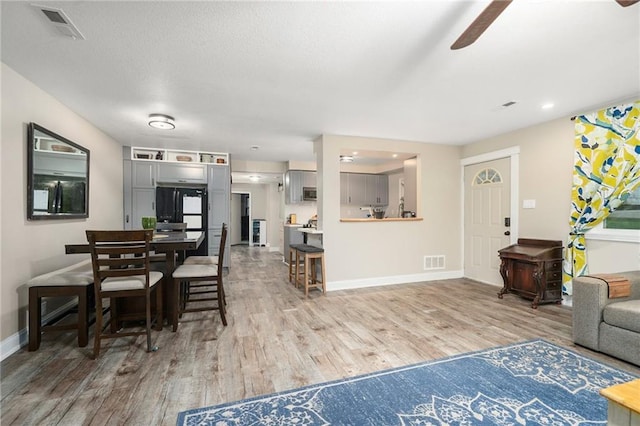 118 Village St, Tonganoxie, KS 66086 - living area featuring light wood finished floors, a ceiling fan, and recessed lighting