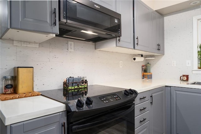 118 Village St, Tonganoxie, KS 66086 - kitchen featuring black appliances, gray cabinetry, decorative backsplash, and light countertops
