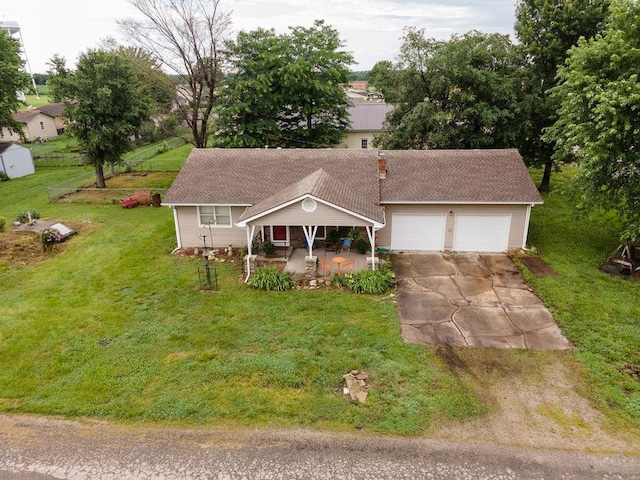 106 S Clark St, Adrian, MO 64720 - view of front facade featuring concrete driveway, a porch, a front yard, an attached garage, and a chimney