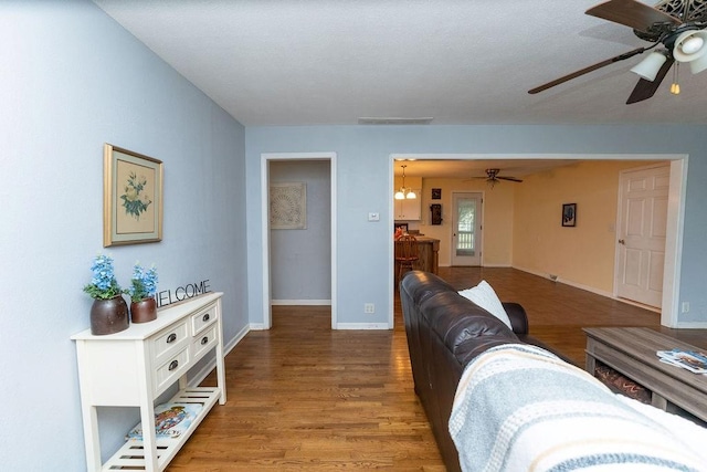 106 S Clark St, Adrian, MO 64720 - living area featuring ceiling fan and wood finished floors