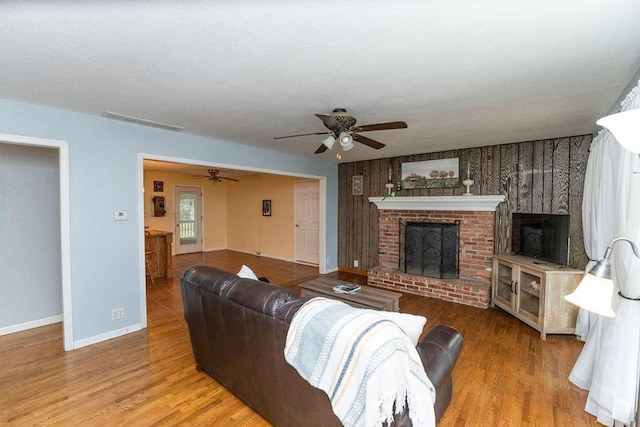 106 S Clark St, Adrian, MO 64720 - living area featuring ceiling fan, a fireplace, and wood finished floors