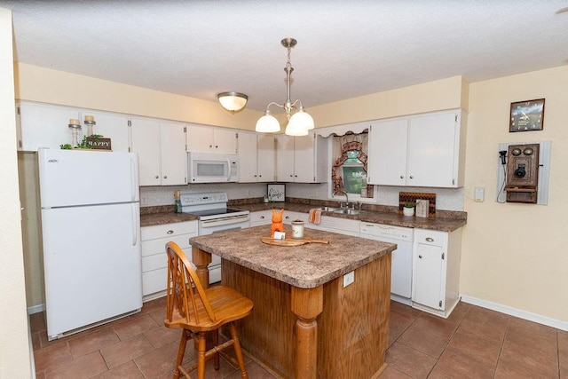 106 S Clark St, Adrian, MO 64720 - kitchen with white appliances, dark tile patterned flooring, and white cabinets