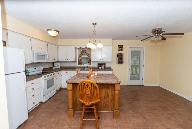 106 S Clark St, Adrian, MO 64720 - kitchen featuring white appliances, white cabinetry, a kitchen island, and pendant lighting