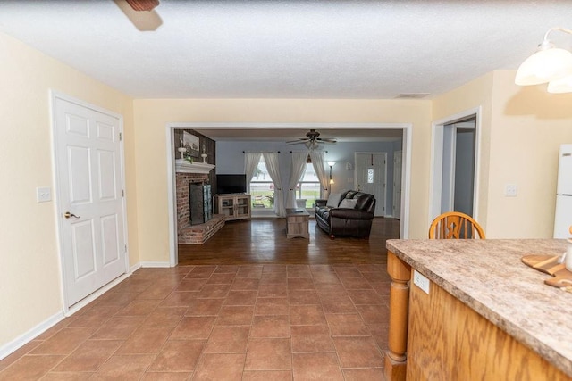 106 S Clark St, Adrian, MO 64720 - living area featuring ceiling fan and a brick fireplace