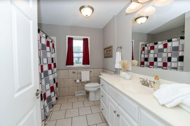 106 S Clark St, Adrian, MO 64720 - bathroom with tile patterned flooring, tile walls, vanity, and a shower with curtain