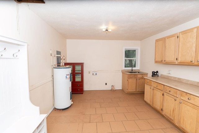 106 S Clark St, Adrian, MO 64720 - kitchen featuring electric water heater, light brown cabinets, light countertops, and light tile patterned flooring