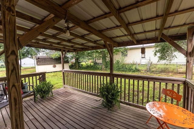 106 S Clark St, Adrian, MO 64720 - deck featuring an outdoor structure and a lawn