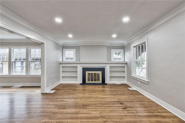 5740 Oak St, Kansas City, MO 64113 - unfurnished living room with crown molding, wood finished floors, a fireplace with flush hearth, and recessed lighting