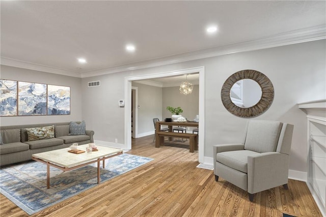 5740 Oak St, Kansas City, MO 64113 - living area featuring light wood-style flooring, crown molding, recessed lighting, and a chandelier
