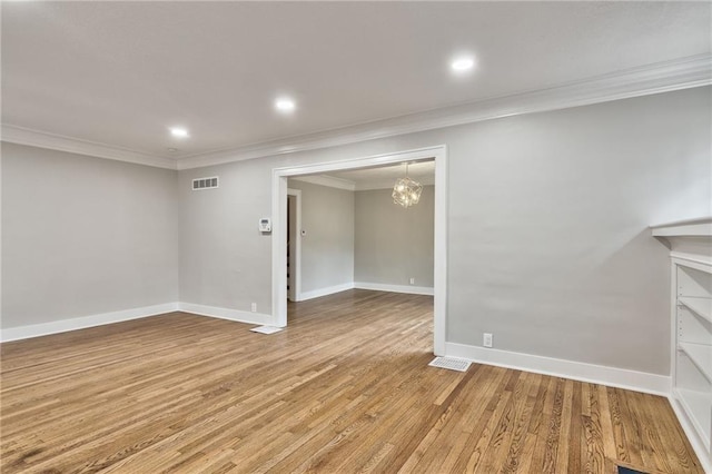 5740 Oak St, Kansas City, MO 64113 - basement featuring crown molding, wood finished floors, a chandelier, and recessed lighting
