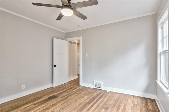 5740 Oak St, Kansas City, MO 64113 - unfurnished room with wood finished floors, ornamental molding, ceiling fan, and healthy amount of natural light