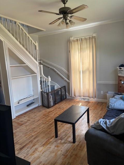 201 W Royle St, Richmond, MO 64085 - living area with crown molding, a ceiling fan, and wood finished floors
