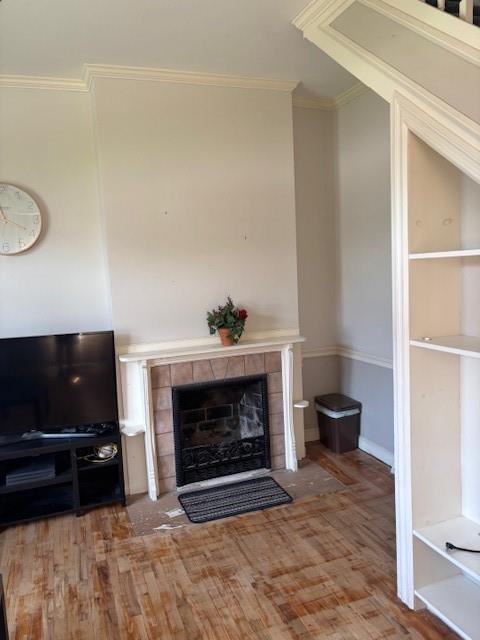 201 W Royle St, Richmond, MO 64085 - detailed view of wood finished floors, a tile fireplace, and ornamental molding