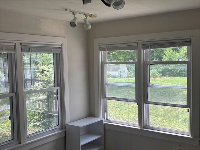 201 W Royle St, Richmond, MO 64085 - unfurnished dining area featuring healthy amount of natural light and track lighting