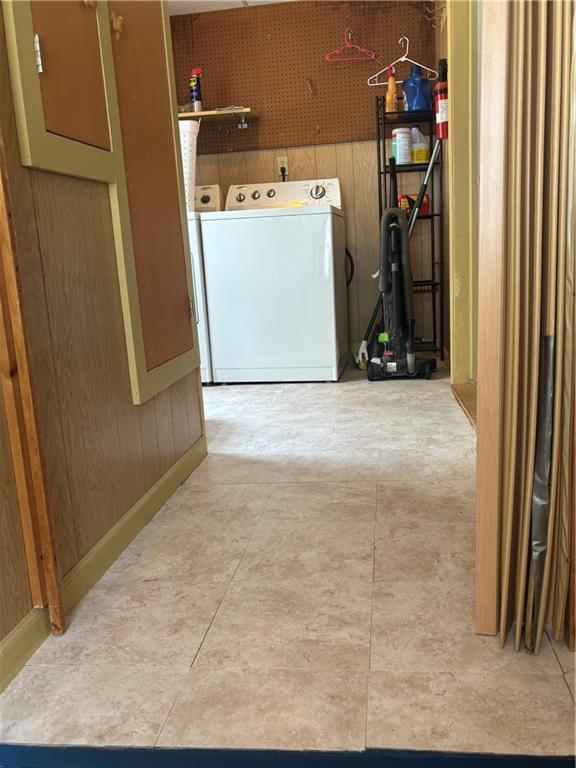 201 W Royle St, Richmond, MO 64085 - washroom with separate washer and dryer and wood walls