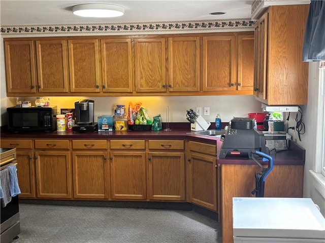 201 W Royle St, Richmond, MO 64085 - kitchen featuring black microwave, brown cabinets, dark countertops, and electric stove