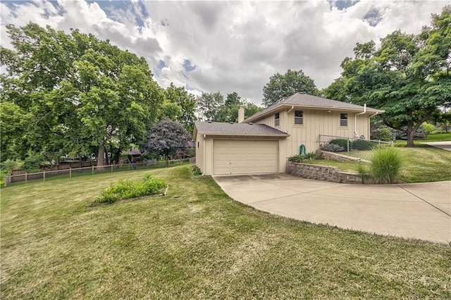 10706 W 50th Ter, Shawnee, KS 66203 - view of side of home with board and batten siding, driveway, a chimney, and an attached garage