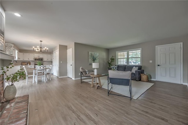 10706 W 50th Ter, Shawnee, KS 66203 - living area featuring a chandelier, wood finished floors, and recessed lighting
