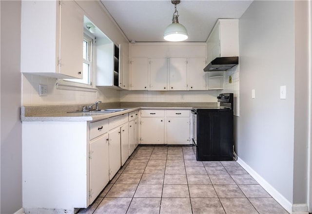 531 S Cedar Ave, Independence, MO 64053 - kitchen with black electric range, under cabinet range hood, light countertops, white cabinetry, and decorative backsplash