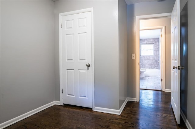 531 S Cedar Ave, Independence, MO 64053 - hall with dark wood-style floors and baseboards