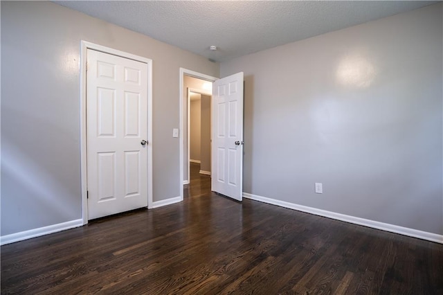 531 S Cedar Ave, Independence, MO 64053 - unfurnished bedroom with dark wood finished floors and baseboards