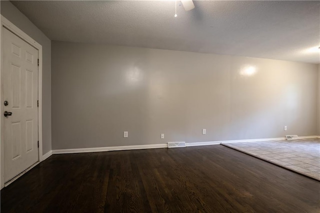 531 S Cedar Ave, Independence, MO 64053 - unfurnished room with dark wood-style floors and a textured ceiling