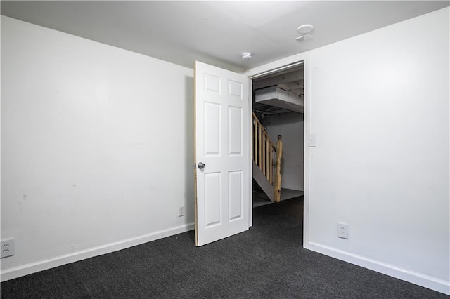 531 S Cedar Ave, Independence, MO 64053 - unfurnished bedroom featuring dark colored carpet and baseboards