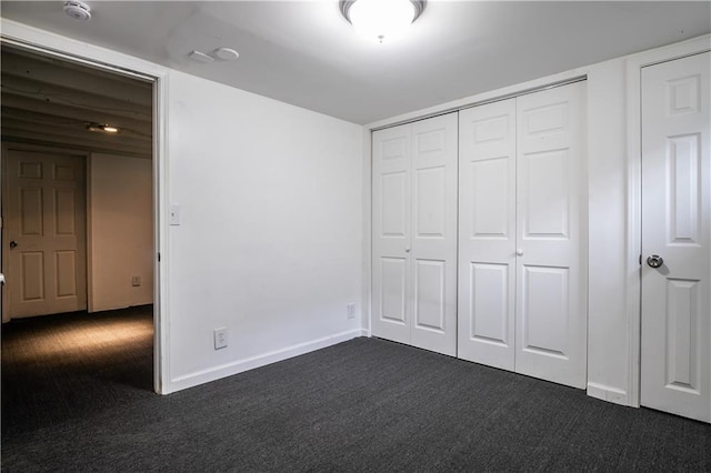 531 S Cedar Ave, Independence, MO 64053 - unfurnished bedroom with dark colored carpet and a closet