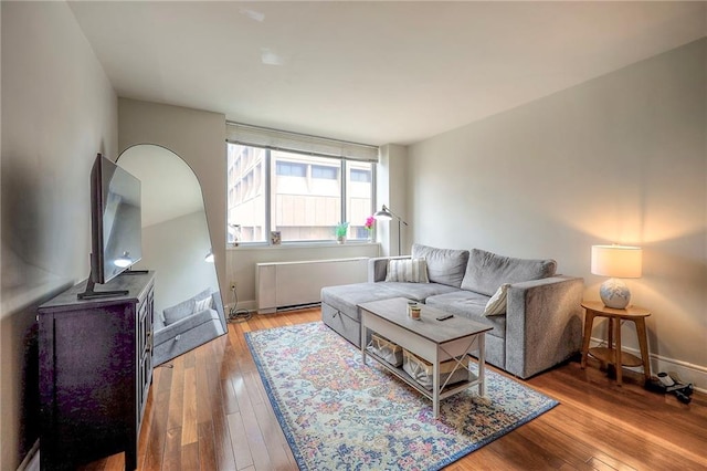 600 E 8th St Unit 4T, Kansas City, MO 64106 - living room featuring radiator heating unit and wood finished floors