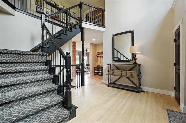 15376 Loring Rd, Bonner Springs, KS 66012 - staircase with wood finished floors and a high ceiling