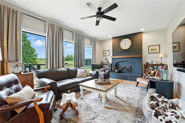 15376 Loring Rd, Bonner Springs, KS 66012 - living room featuring a fireplace, a ceiling fan, wood finished floors, and recessed lighting
