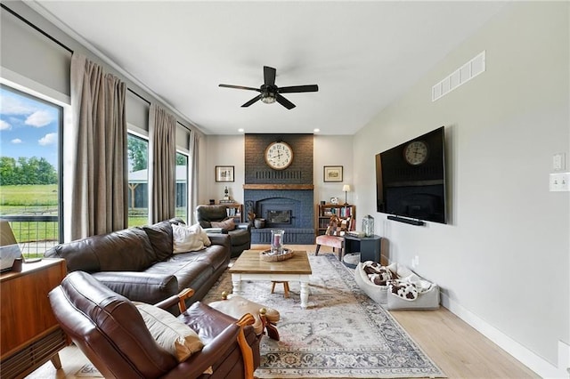 15376 Loring Rd, Bonner Springs, KS 66012 - living room with ceiling fan, wood finished floors, and a brick fireplace
