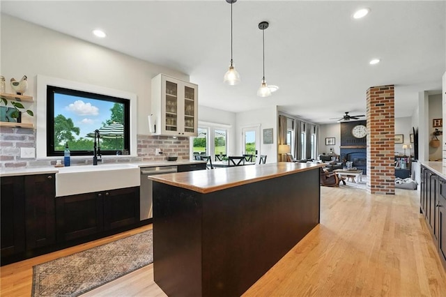 15376 Loring Rd, Bonner Springs, KS 66012 - kitchen with dishwasher, a ceiling fan, light countertops, a large fireplace, and white cabinets