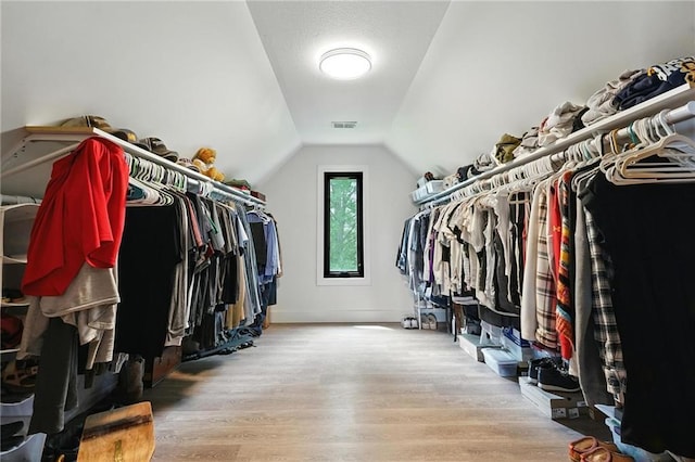 15376 Loring Rd, Bonner Springs, KS 66012 - walk in closet featuring wood finished floors and vaulted ceiling